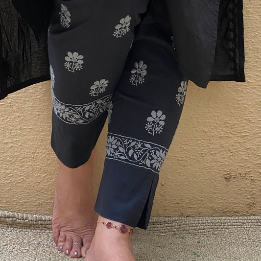 Black cotton straight pants with grey flower motif and a floral border